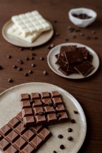 Close-up of various chocolate types on rustic plates, showcasing texture and indulgence.